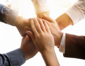 Showcasing hands stacked together in harmony, symbolizing unity, cooperation, teamwork, and