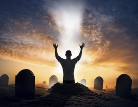 A silhouette of a lone figure walking off a gravestone, The scene evokes Resurrection thoughts