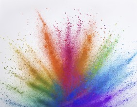 Vibrant and energetic multicolored powder explosion captured against awhite background. Evoking