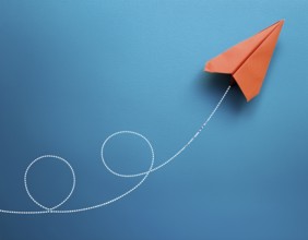 Simple artwork depicting a stylized paper airplane soaring gracefully with a looped trajectory.