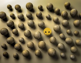 Wooden balls feature faces, one smiling among sad expressions, representing positivity or