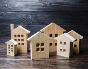 A collection of small wooden model houses with cozy lighting, creating a warm and inviting