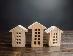A collection of small wooden model houses with cozy lighting, creating a warm and inviting