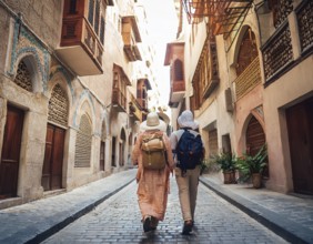 Travelers walk through an scanic architecture and culture of Muslim country, AI generated