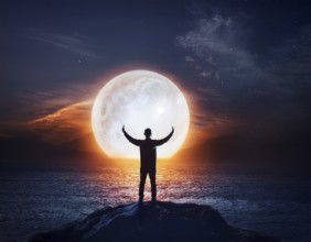 Man silhouette with giant glowing moon in night sky, symbolizing reflection, cosmic mystery, and
