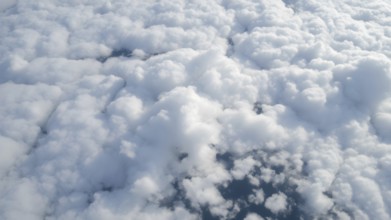 Aerial view on white fluffy clouds. View of the clouds from above, AI generated