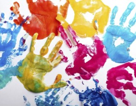 Vibrant multicolored handprints on white background, symbolizing creativity, playful expression,