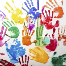 Vibrant multicolored handprints on white background, symbolizing creativity, playful expression,