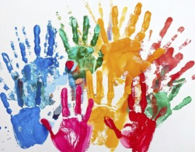 Vibrant multicolored handprints on white background, symbolizing creativity, playful expression,