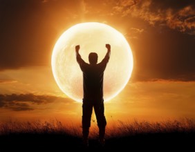 Man silhouette against giant glowing sun symbolizing inspiration, destiny, reflection, cosmic