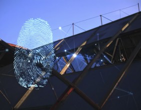 Glowing digital fingerprint wall art symbolizing cybersecurity, identity protection, and futuristic