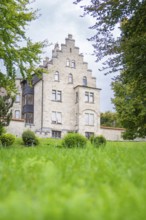 A Gothic castle rises imposingly above a green lawn under a clear sky, Lichtenstein Castle,