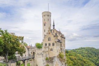 Medieval castle on a hill with green trees and blue sky, Lichtenstein Castle, Lichtenstein, Swabian