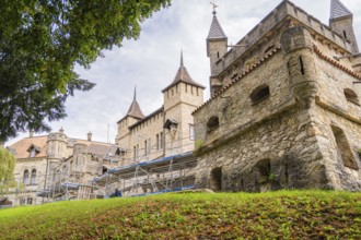 Old castle with towers and scaffolding for renovation in green surroundings, Lichtenstein Castle,