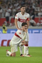 Ermedin Demirovic VfB Stuttgart (09) massages Angelo Stiller VfB Stuttgart (06) 's shoulder,