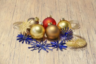 Christmas decoration with home-made straw stars and Christmas tree baubles, Germany