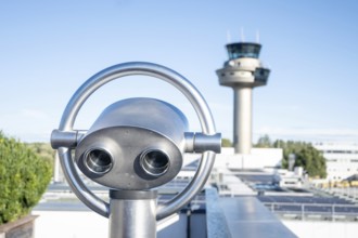 Binoculars for visitors aimed at the tower of Salzburg Airport, Austria
