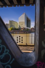 Long-term photograph of the mirror building through a steel girder of the Oberhafenbrücke bridge at