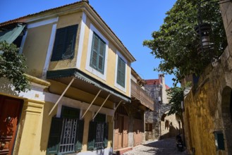 Colourful house facades with shutters in a historic alley, Turkish Quarter, Rhodes Old Town, Rhodes