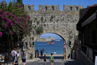 Panagia Tor, natural stone archway with a view of the sea and passing tourists, Rhodes Old Town,