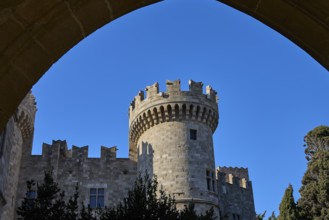 Tor tor Grand Master's Palace, castle with imposing tower and battlements, framed by a strong blue