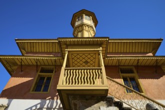 Ottoman building with wood-decorated tower and balconies that stand out majestically against the