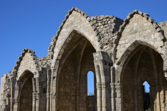Church of Virgin Mary of the Castle, Gothic ruins with striking arches under a clear blue sky,