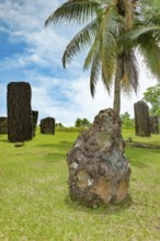 In the foreground ancient stone monolith Stone monolith in the shape of head with unexplained