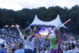 Children with lightsabers at the 25th Berlin Flashlight Concert at the Berlin Waldbühne on