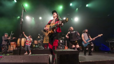 Eugene Hütz, centre, singer and guitarist, Gogol Bordello, folk-punk band, USA, live on Fall 2025