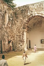 People inside ruined church of Saint Paul Malacca or Melaka, Malaya, Malaysia, south east Asia 1964