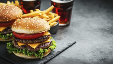 Savory Homemade Burgers, Crispy French Fries, And Refreshing Cola On A Neutral Background With Room