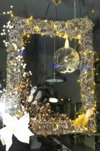 Festive christmas decoration illuminating a shop window in bayonne, france, creating a warm and