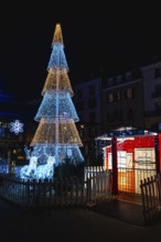 Luminous christmas decorations illuminating bayonne city center at night with reindeer and