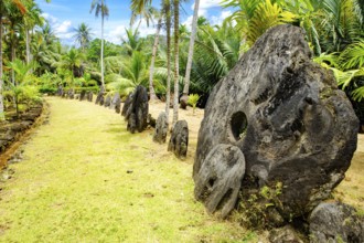 Oversized large giant stone coins real currency in stone money bank stone money bank in jungle of