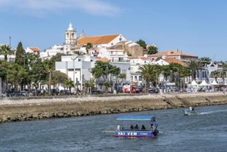 The skyline of the old town of Lagos, on the river Bensafrim, harbour canal, passenger ferry across