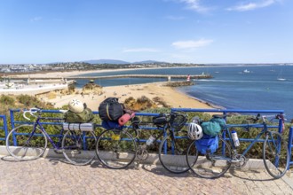 Bicycles with luggage, above the beach Praia da Batata, in the city centre of Lagos, in the west of