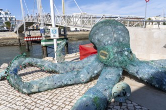 Figure of an octopus, filled with PET bottles, plastic products, reminder not to produce so much