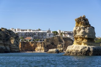 Praia Dona Ana beach, hotel buildings, Ponta da Piedade rocky coast, rugged coastal landscape,