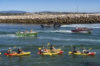 Kayak tours to the rocky coast of Ponta da Piedade, groups of tourists kayak on the sea to the
