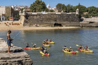 Kayak tours to the rocky coast Ponta da Piedade, groups of tourists in kayaks on the sea to the