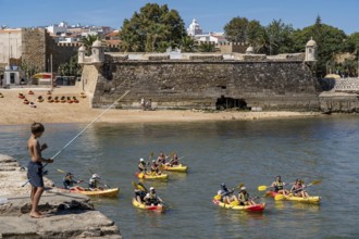 Kayak tours to the rocky coast Ponta da Piedade, groups of tourists in kayaks on the sea to the