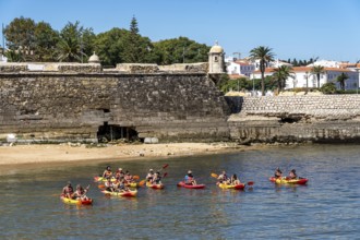 Kayak tours to the rocky coast of Ponta da Piedade, groups of tourists in kayaks on the sea to the