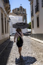 Old town alley in Faro, view of the cathedral of Faro, Algarve, Portugal