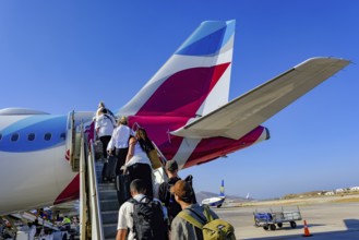 Mykonos, Greece - EUROWINGS. At Mykonos Airport, holidaymakers board a Eurowings aircraft via an