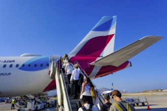 Mykonos, Greece - EUROWINGS. At Mykonos Airport, holidaymakers board a Eurowings aircraft via an
