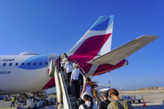 Mykonos, Greece - EUROWINGS. At Mykonos Airport, holidaymakers board a Eurowings aircraft via an