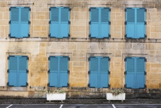 Closed, green shutters, historic house facade, yellow sandstone, Marville, Renaissance village,