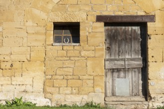 Wooden door, window, historic house facade, yellow sandstone, Marville, Renaissance village,