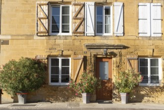 Renovated building, historic house façade, yellow sandstone, Marville, Renaissance village,